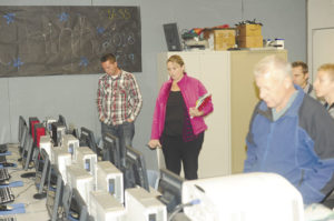 Oroville School Board members Travis Loudon, Rocky DeVon and Todd Hill, with OHS Principal Kristin Sarmiento look over one of the computer labs at Oroville High School. They were on a facilities tour of the high school, part of the board's ongoing  program of touring district facilities at regular intervals throughout the year. Gary DeVon/staff photo