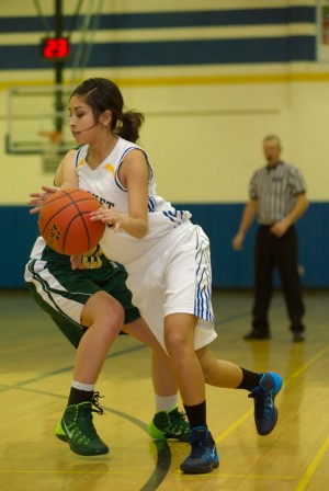 The Tigers' Jenny Bello drives past Liberty Bell for two points on Saturday.
