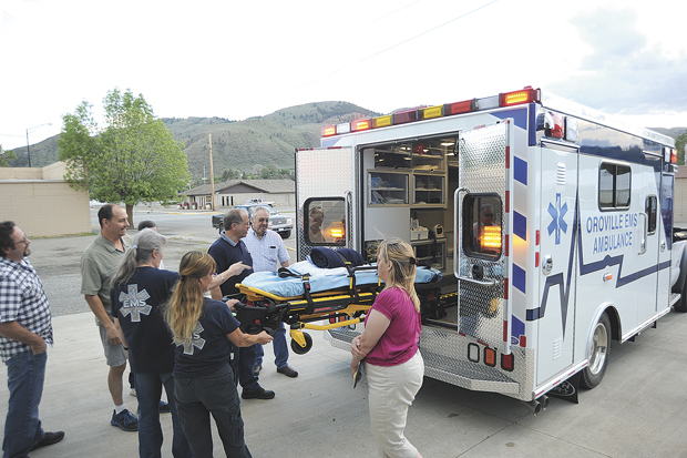 Oroville Ambulance Coordinator Debra Donahue and EMT Jackie McDaniels demonstrate the ease with which patients can be loaded and unloaded from Oroville's new ambulance using the power gurney. Gary DeVon/staff photo