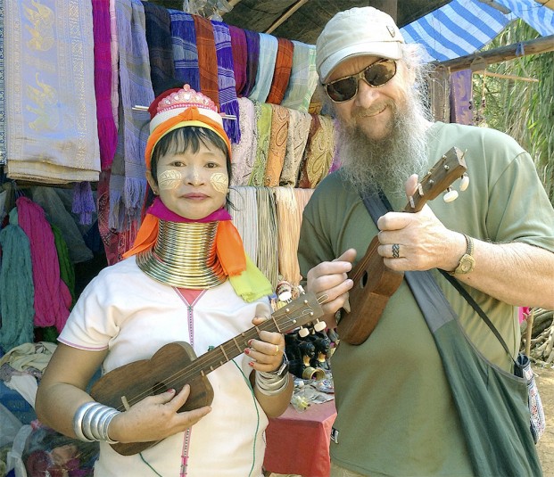 John Jones, right, shares his love of music with a Cambodian woman on his recent trip to visit the remote village where he once fought - and was severely wounded - during the Viet Nam War.