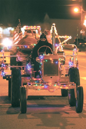 Santa and Mrs. Claus hitch a ride on a lighted tractor during last year's parade. Gary DeVon/file photo