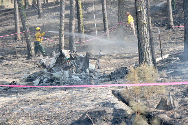 DNR firefighters were still hitting hot spots at the crash site of a Cessna T182 Friday afternoon. The crash was near Rise Road, about 400 yards from the ranch, according to Brandy Rise, who reported the crash Thursday afternoon. Gary DeVon/staff photo