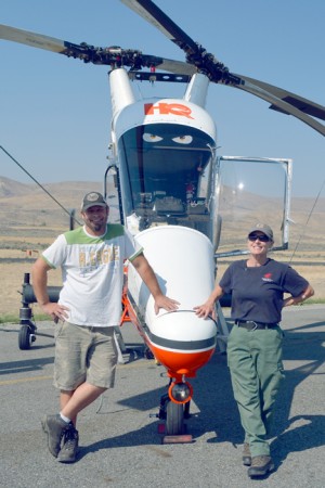 Phil Melton, pilot, and Helicopter Manager Kim Knox stand next to the K-Max Melton flies. Katie Teachout/staff photo