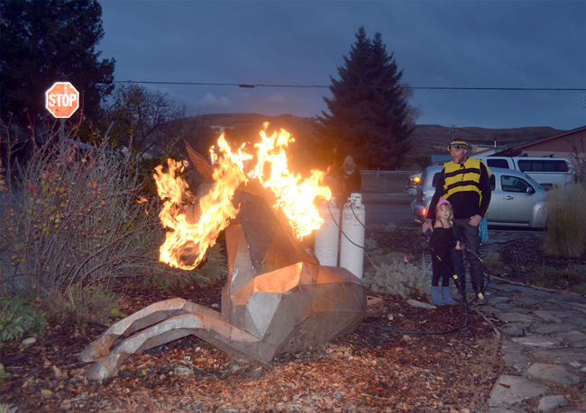 Quill Hyde and his daughter JoJo captivate Tonasket Trick or Treaters by lighting the Mer Pony’s head on fire when ghouls and goblins, Scoobie Doos and princesses approach the walkway Oct. 31.