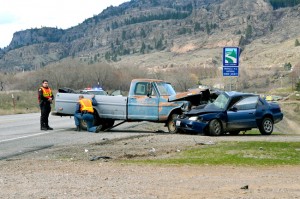 Officers from the Washington State Patrol and the Okanogan County Sheriff's office investigate the accident scene of a fatal two car collision about seven miles south of Oroville last Tuesday afternoon. Katie Teachout/staff photo