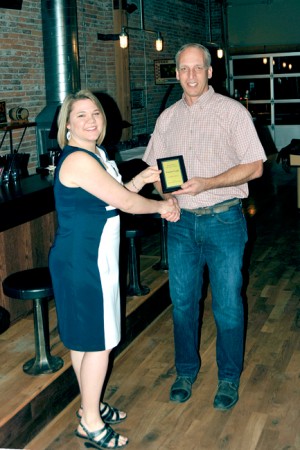 Pat Davisson is presented a plaque for “Business of the Year” for his and wife Jody’s Frontier Foods.