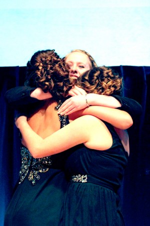 Mikaela McCoy shows excitement  and hugs fellow state champs Tori Kindred and Ellamae Burnell.