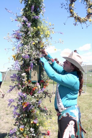Miss Omak Stampede 2015 Menze Pickering places flowers on the May Pole at last year's Molson Midsummer Fest. GT File Photo