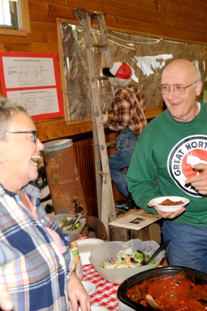 GNRR-Group-2-Vert-39 edi Lynn Fletcher serves up stew and shares a laugh with a a member of the Great Northern Railway Historical Society. The tour started in Spokane last Thursday morning and travelled through Hillyard to Kettle Falls stopping at all stations. Along the way they discussed and viewed Orient, Curlew, Republic and the Eureka Gulch. On Friday they went over Molson Hill into Oroville and up to Nighthawk ending in Omak. On Saturday the plan was to cover from Omak to Wenatchee stopping at all stations and then back to Spokane. Gary A. DeVon/staff photo September 23, 2016