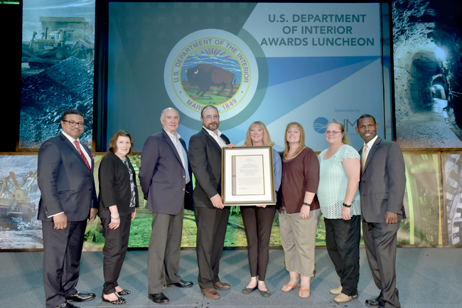 Submitted photo Employees of the U.S. Bureau of Land Management, Kinross Gold Company and Kinross Kettle River Buckhorn, gathered for the presentation of the Bureau's 2016 Hardrock Mineral Community Outreach and Economic Security Award at the Las Vegas Convention Center during MinEXPO 2016, at the US Department of Interior Awards Luncheon hosted by the National Mining Association. They are (l-r) Mitchell Leverette, Division Chief Solid Minerals, BLM; Mary Linda Ponticelli, Solid Minerals Specialist, BLM; Warwick Morley-Jepson, Executive Vice-President and Chief Operating Officer, Kinross Gold; Mark Ioli, Vice-President & General Manager, Kinross Kettle River – Buckhorn; Deana Zakar, Community Relations & Corporate Responsibility, Kinross Kettle River – Buckhorn; Gina Myers, Environmental Manager, Kinross Kettle River – Buckhorn; Jacquelyn Nutt, Environmental Superintendent, Kinross Kettle River – Buckhorn and Michael Nedd – Assistant Director, Energy, Minerals and Realty Management, BLM.
