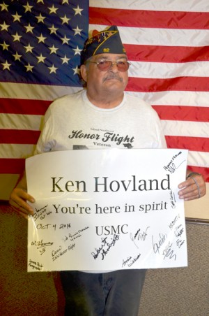 William Gomez and his sign honoring his friend Ken  Hovland.