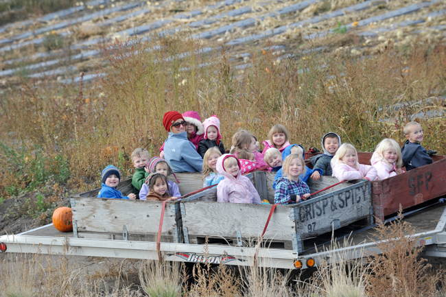 Gary DeVon/staff photo Youngsters got a ride on a trailer and a chance to pick their own pumpkins at Taber's Taste of Summer Fruit Barn a few weeks before Halloween. The pumpkin patch was  sponsored by Taber's and Lake and Country RE/MAX Realty in Oroville.