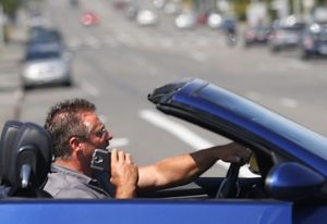 A distracted driver on his phone. Penalties for talking without a hands-free device may soon get much stiffer in Washington State.