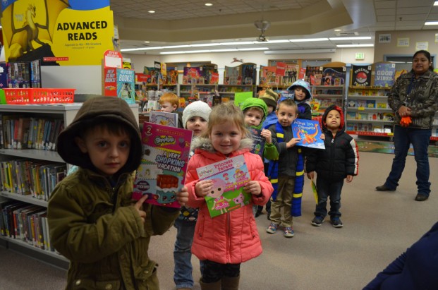 Katie Teachout/staff photo Preschoolers in Avalia Zabreznik's class show off books they got to choose for free. A total of 534 books were given to Tonasket Elementary School students this week.