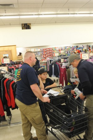 Oroville Councilman David "Mac" McElheren helps pick out close for one of the kids.