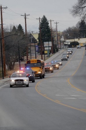 A bus full of kids get a police escort to the Country Store following a lunch at the American Legion