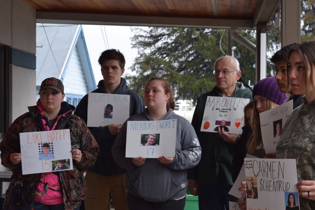 Wenatchee Valley College Omak students and community members hold signs honoring the 17 victims from Parkland, Florida one month ago.