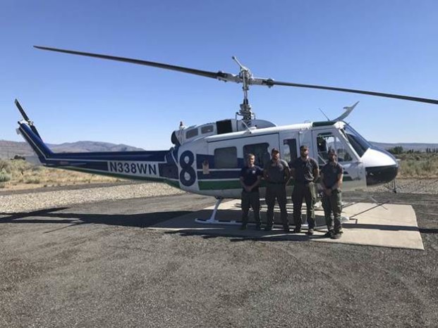 DNR/submitted photo The DNR helicopter crew from Omak yesterday, July 12, after their mission. Left to right are Daryl Schie (helicopter manager), Matthew Harris (crew), Jared Hess (crew) and Devin Gooch (pilot).