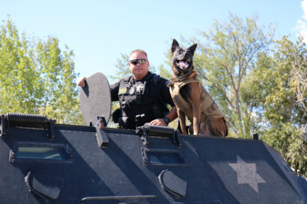 Havoc shows off his protective vest alongside his handler, Sergeant Tait Everett. Tanya Craig/submitted photo 