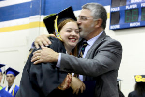 Anna McCullough recieves a warm hug and her diploma from her father Superintendent Steve McCullough. 