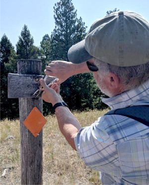 Bill Kresge, OHA volunteer, repairing and improving signage along the trail.