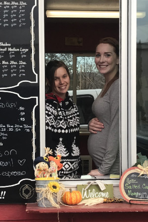 Laura Knowlton/staff photo Kelli Vanetta and Heather McDaniel offer warm coffee, a bright smile and recall reasons to be grateful this holiday season.