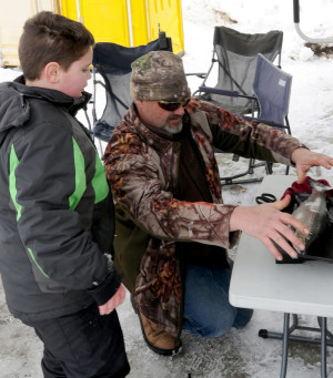 Official NW Ice Fishing Festival judge Greg Morey weighs in the 2019 first place fish in the Youth Division which was caught by Ezchial Pruett from the Spokane Valley. His fish was 2 lbs., 13 oz and 17.25 inches long.