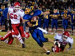 Tiger senior quarterback Sean Timmerman looks to create yardage at midfield against Brewster on Friday night. Despite a scoreless second half, the Bears beat Tonasket 21-13.