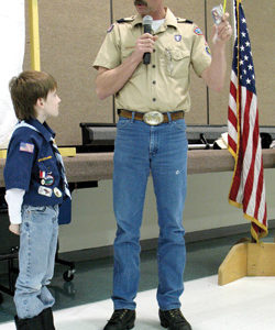 Bear Cub Josh Crazy receives badges from Kelvin Davis during the awards ceremony Jan. 6.