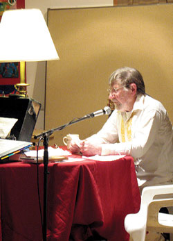 234a Curtiss Howard read some of his pieces and performed emcee duties at the reading. He read biographies, written by each writer, before they took to the mike. Many of the bios were, he said, t