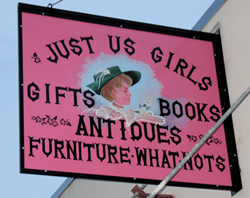 Photo by Amy VenezianoThe sign for Just Us Girls, on the south side of the Subway building on the corner of Fourth Street and Whitcomb, signals shoppers from Highway 97.
