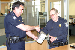 Photo by Gary DeVon&amp;nbsp;&amp;nbsp;&amp;nbsp; Port Director Ron Arrigoni (left) presents Mel Lindauer with several gifts in honor of his 33 years of service at the U.S. Port of Entry. Lindauer retired from th