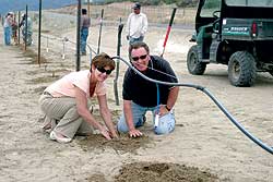 Photo by Gary DeVonDevelopers Lisa and Jim Hammond plant one of the first barbera grape vines that will become the Veranda Beach Resort vineyard.