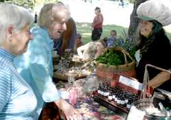 File Photo	Mariah Cornwoman, owner of CWRay, LLP Farm and Forest Products attempts to temp a couple of festival-goers with one of her many garlic-based products at last yearâ€™s Okanogan River Garlic Festival in Tonasket. The festival, sponsored by t