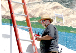 Photo by Gary DeVon    Artist David Heck began his part of the Centennial Mural Project with a painting of a local vineyard. The Bothell-based artist is well-known for his work on the west side of the state where he has be