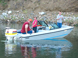 Photo by Linda Baker Captain Pat Sutton, Callie Krupkat and Kevin Krupkat fishing on Upper Conconully Lake in a youth bass tournament put on by the Bible Faith Family Church.