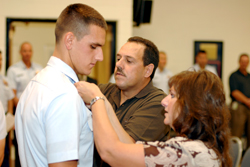 Submitted photo  Michael and Karen Hicks traveled to North Carolina for their sonâ€™s graduation from the Coast Guardâ€™s Rescue Swimmer Program. Here they participate in the â€œpinningâ€ ceremony.