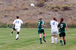 Photo by Emily Hanson Tonasket girls Shelby Olma (24) and Meghan Newton (4) racing to the ball against Liberty Bell’s Miranda Glenn (7) and Jennie Stahl (5) in the Thursday, Oct. 2 game. The Tigers lost to Liberty Bell 4