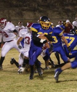 Photo by Terry MillsSenior Justin Mann protects the football as he works his way through Okanogan and Tonasket players during Tonasket’s home game against Okanogan on Friday, Oct. 24.