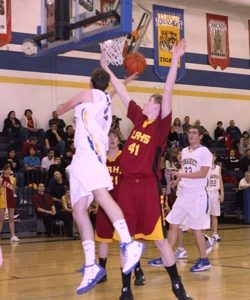Photo by Terry MillsSenior Austin Olma of Tonasket tries to make a shot from under the hoop in Tonasket's game against Lake Roosevelt on Tuesday, Jan. 13. The Tigers lost, 66-39. Also shown are freshman Ty Egbert of Lake Roosevelt, senior Bryce Johnson (#