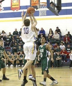 Tonasket senior Jeramy Dellinger jumps to make a shot over Joe Harris, a junior from Chelan, on Saturday, Jan. 31 Tonasket lost 81-42.Photo by Terry Mills