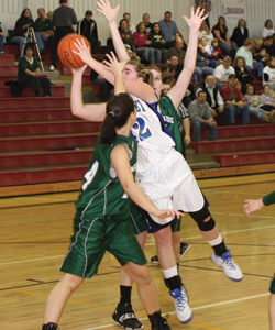 Tonasket senior Cierra Silverthorn leaps over two LakesideHigh School players during the Lady Tiger’s