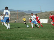 Photo by Emily HansonJeovanny Polito (9) trying to kick the ball away from Omak during Tonasket’s home game on Thursday, April 16. The Tigers lost the game 3-0. Also shown are Michael Hulse (16) and Damien Rangel (15).