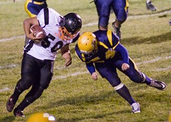 Hornet Caleb Whiteaker goes for the tackle. He and Charlie Demartino teamed up on defense to keep Bridgeport contained all night by not letting them get outside, according to Coach Tam Hutchinson. Photo by Eric Teela