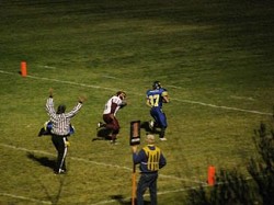 Tonasket sophomore running back John Stedtfeld scoring the fifth Tonasket touchdown during the Tiger’s game with the Lake Roosevelt Raiders on Friday, Oct. 16. Also shown is Raider freshman linebacker Shawn Waters, who was unable to stop Stedtfeld’s f