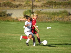 Tonasket freshman Kelly Cruz works on stealing the ball from a Brewster girl during Tonasket’s home win on Tuesday, Sept. 22.Photo by Emily Hanson