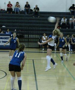 Tonasket junior Brooke Ray jumps up to hit the ball over the net during Tonasket’s home game against Omak on Tuesday, Sept. 29. Also shown are junior Jessica Rhoads (#11), sophomore Amber Kilpatrick (#3) and sophomore Taylor Ayers (#2).Photo by Emily Ha