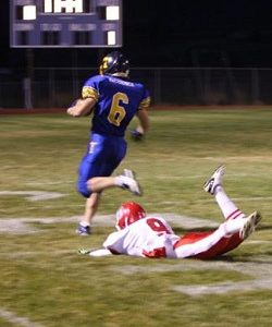 Tonasket junior running back Keegan McCormick runs toward the end zone for the first touchdown of the night, scored 23 seconds into the game, as the last Brewster defender with a chance of stopping him, freshman defensive back Danny Ramirez, falls to the