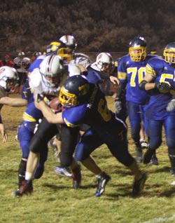 1045a Tonasket defensive back Keegan McCormick tackling an Omak running back on Thursday, Oct. 29. The Pioneers were too fast for the Tigers and Tonasket lost at home 48-7. Photo by Terry Mills