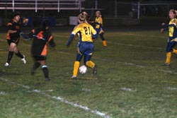 Naomi Peters moves the ball across the field in a home match against Bridgeport last Thursday. The Hornets lost after two sudden-death tie-breakers after regulation play. Photo by Gary DeVon